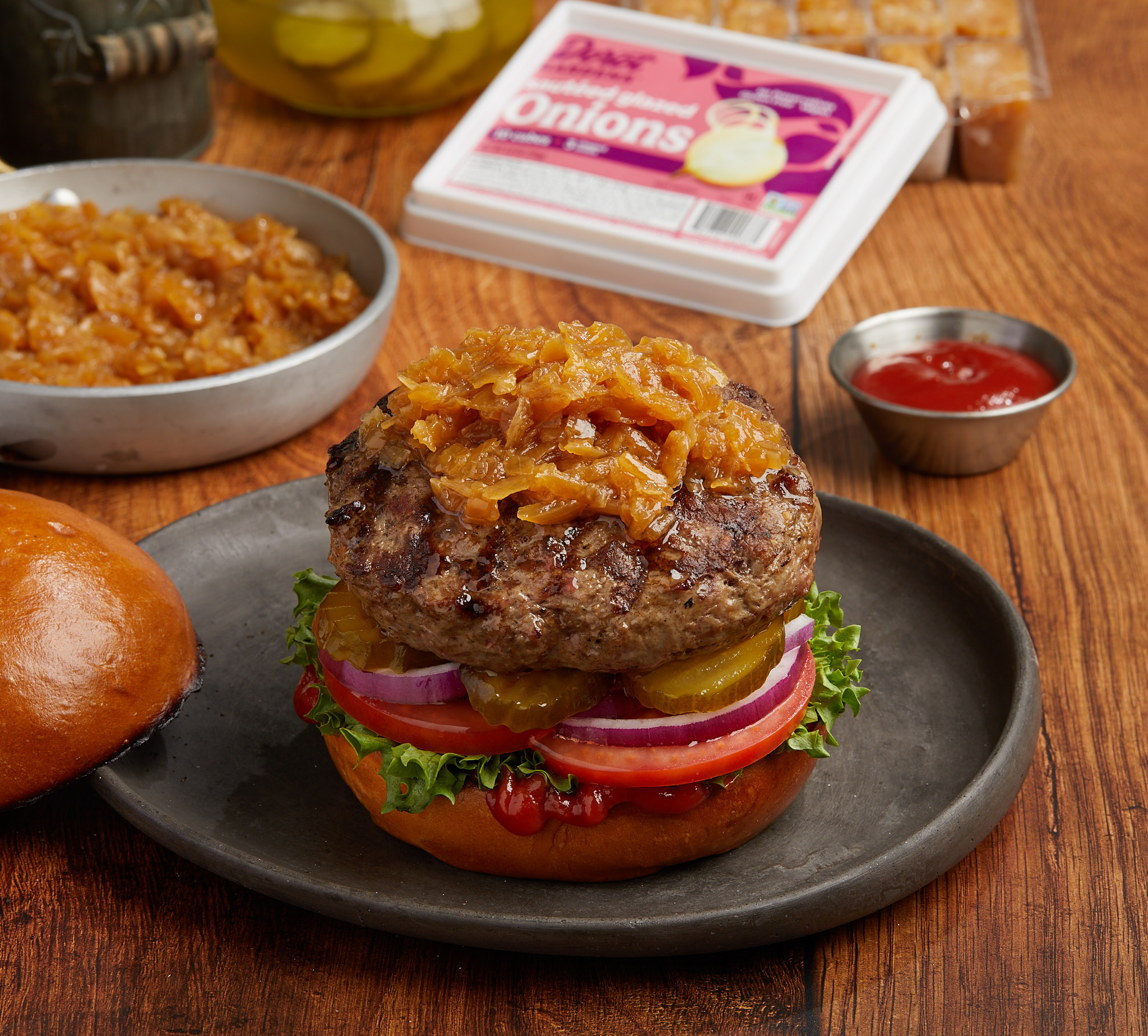 Juicy burger patty topped with caramelized onions, evoking the rich flavor boost provided by Dorot Gardens sautéed onion cubes.